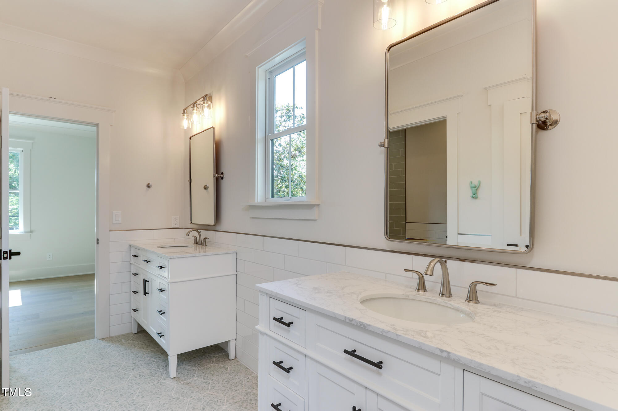 4921 Sweetbriar Drive Raleigh, NC 27609 - Photo 31 of 42 a bathroom with double sink and a mirror