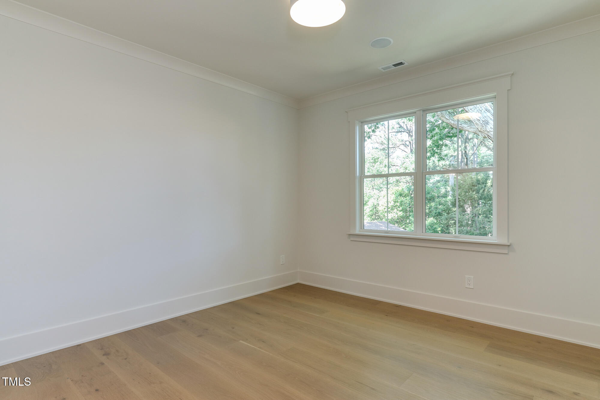 4921 Sweetbriar Drive Raleigh, NC 27609 - Photo 33 of 42 an empty room with a window