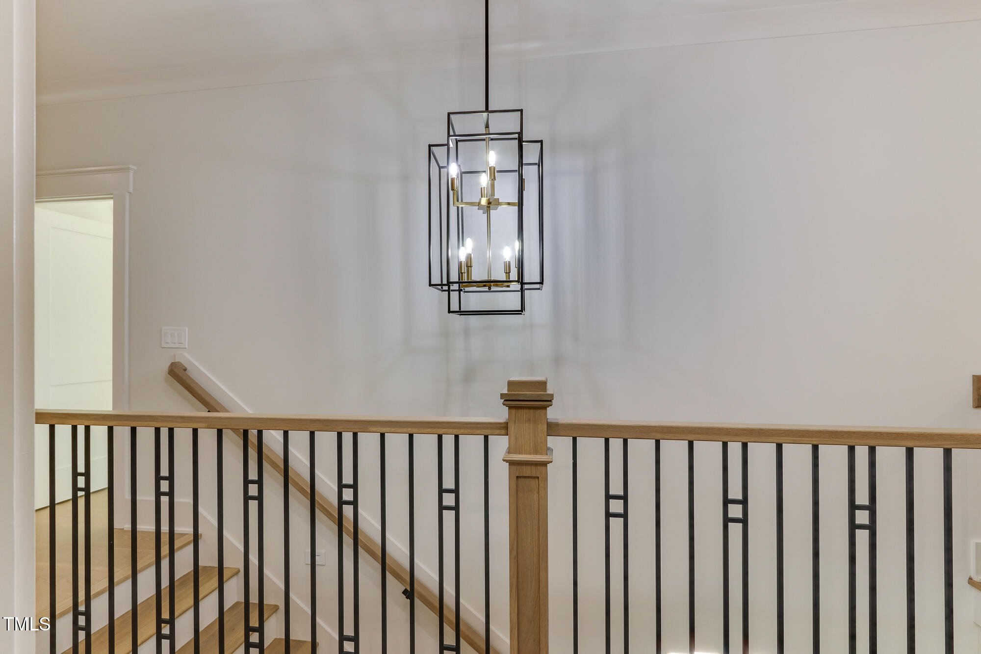 4921 Sweetbriar Drive Raleigh, NC 27609 - Photo 35 of 42 a view of a hallway with wooden floor and stairs