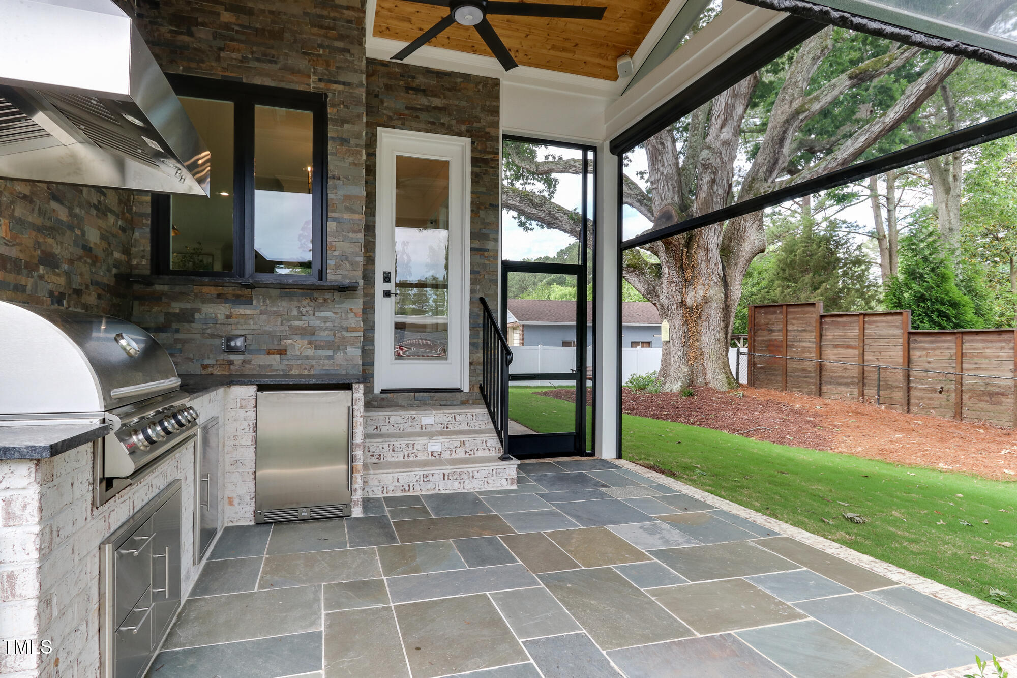 4921 Sweetbriar Drive Raleigh, NC 27609 - Photo 36 of 42 a view of a porch with wooden floor and a yard