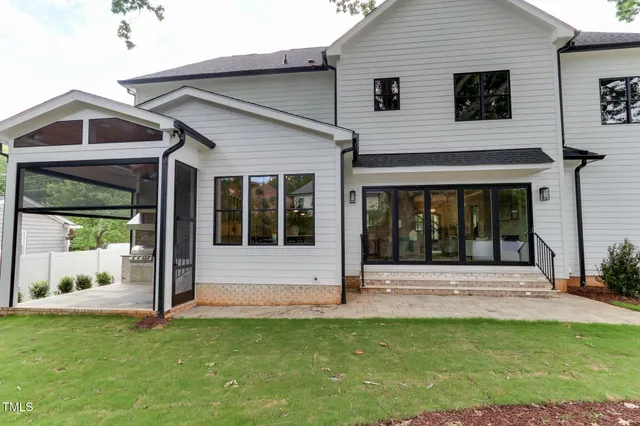 a view of a house with backyard and tree