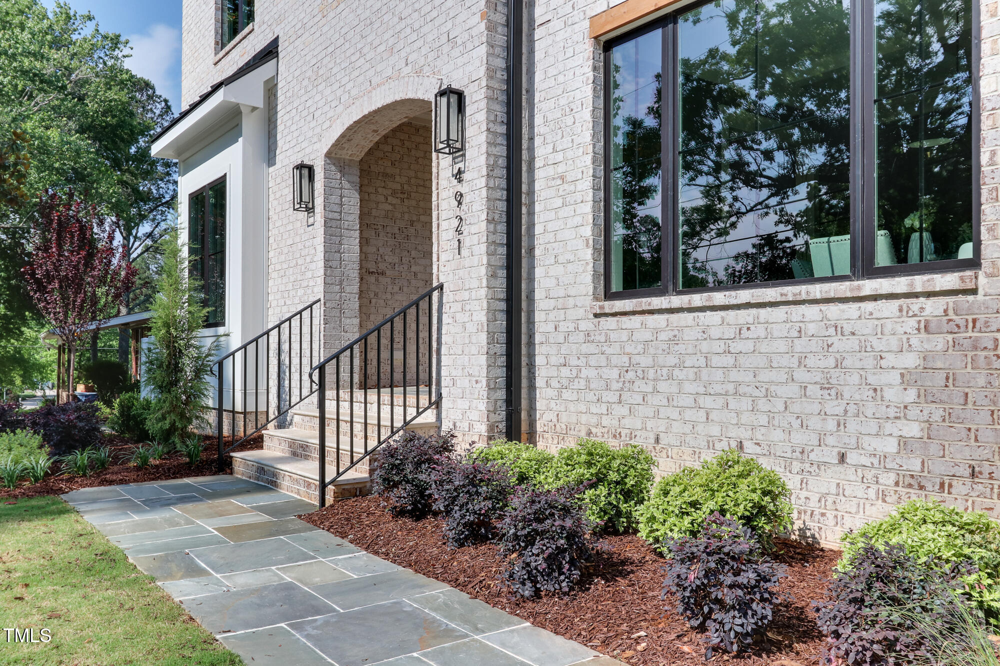 4921 Sweetbriar Drive Raleigh, NC 27609 - Photo 3 of 42 a view of a house with brick walls and flower plants