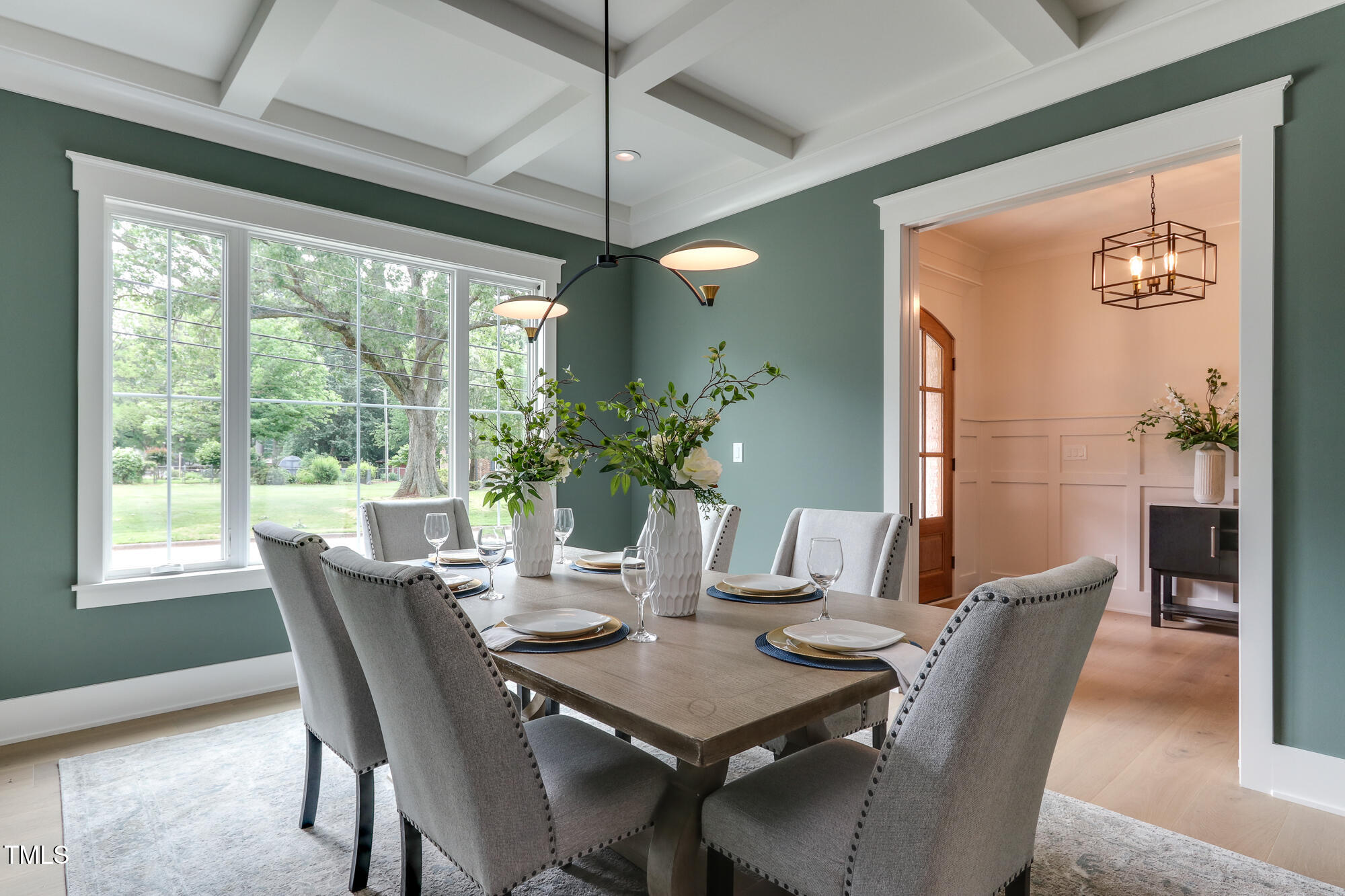 4921 Sweetbriar Drive Raleigh, NC 27609 - Photo 4 of 42 a dining room with furniture potted plants and wooden floor