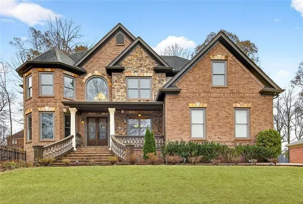 a front view of a house with a yard