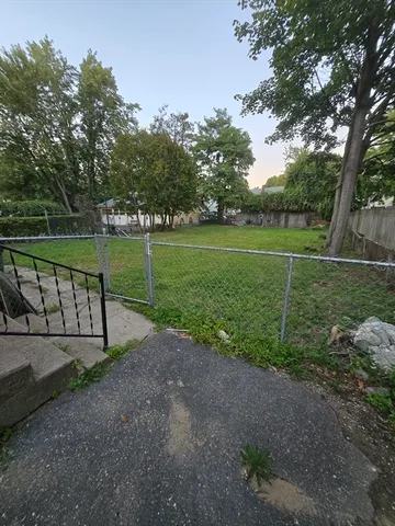 a view of a park with large trees