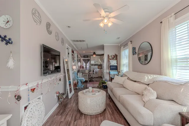 a living room with furniture and wooden floor
