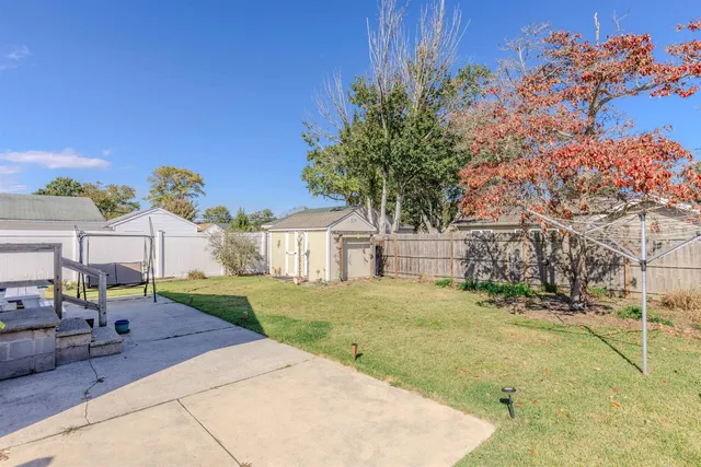 a view of a house with backyard porch and sitting area