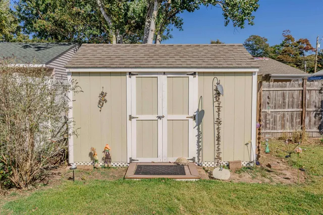 an aerial view of a houses with a yard and lake view
