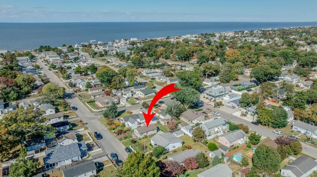 an aerial view of a houses with a yard
