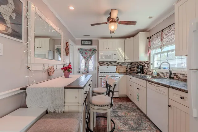 a kitchen with stainless steel appliances kitchen island granite countertop a sink and cabinets