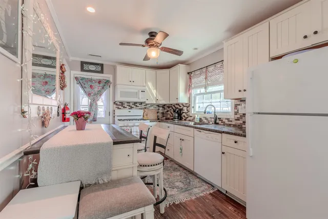 a kitchen with stainless steel appliances a sink stove and cabinets