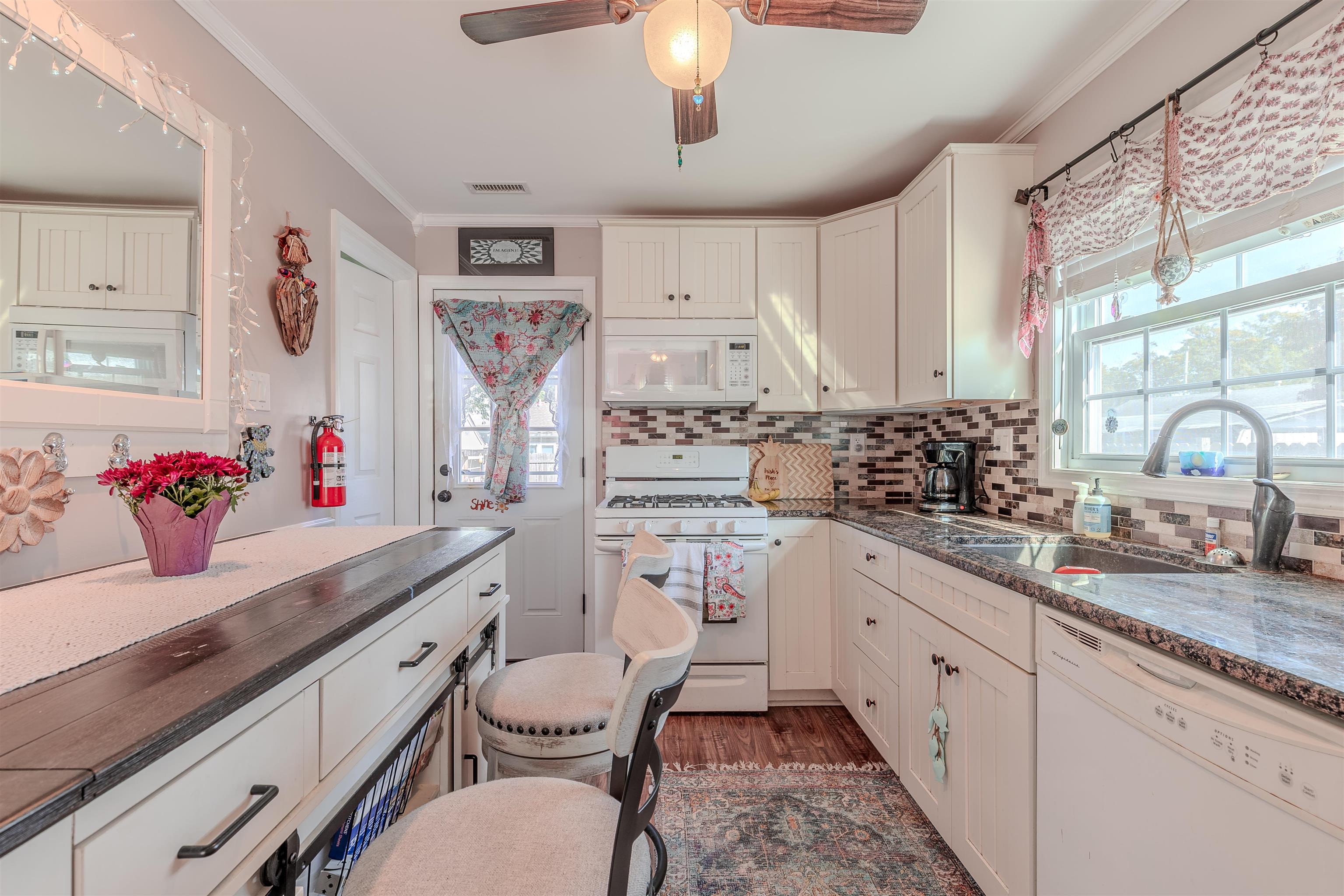 143 Arbor Road Villas, NJ 08251 - Photo 7 of 32 a kitchen with stainless steel appliances a sink stove and cabinets