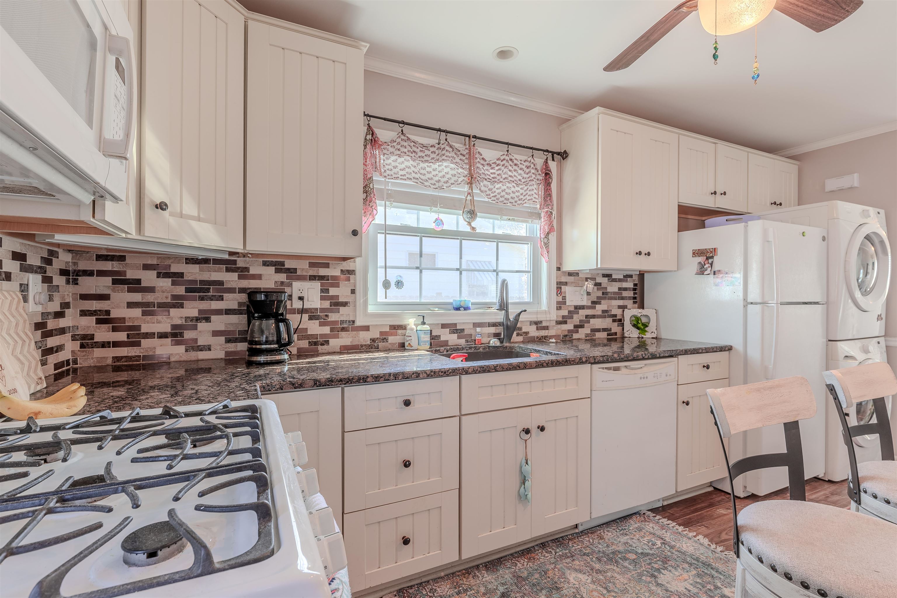 143 Arbor Road Villas, NJ 08251 - Photo 8 of 32 a kitchen with white cabinets and white appliances