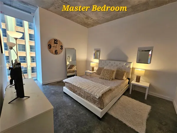 a living room with furniture and a floor to ceiling window