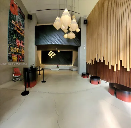a living room with a table a chair and a wooden floor