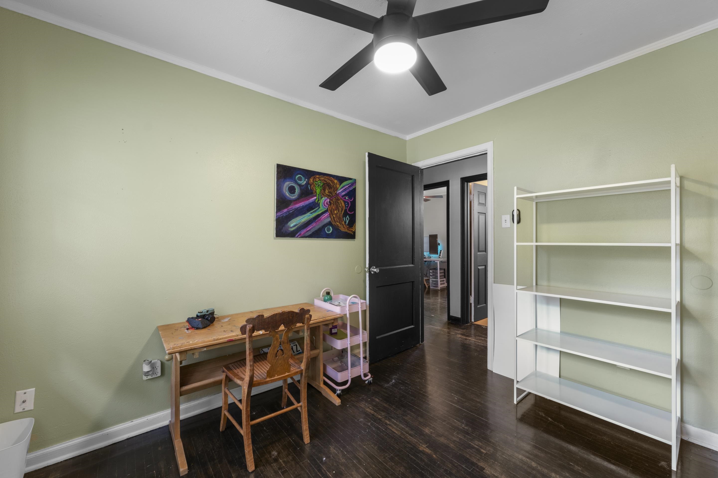 1343 Dearing Road Memphis, TN 38117 - Photo 14 of 19 Room featuring wood-finish flooring, light green walls, white trim, and a ceiling fan with integrated lighting