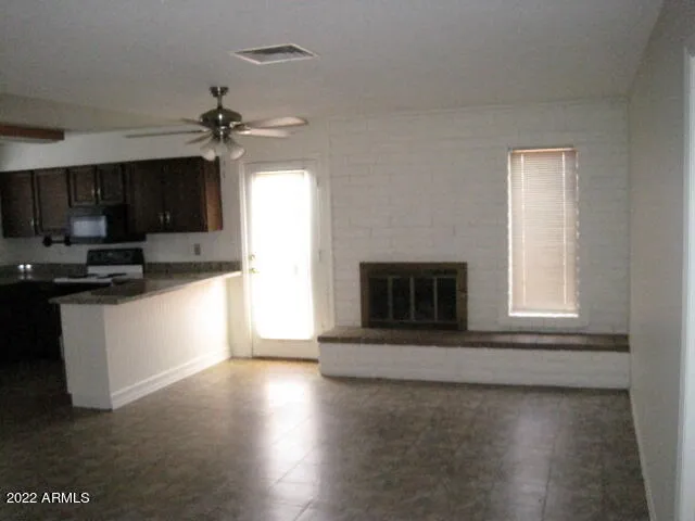 a view of a kitchen with a sink a microwave and cabinets
