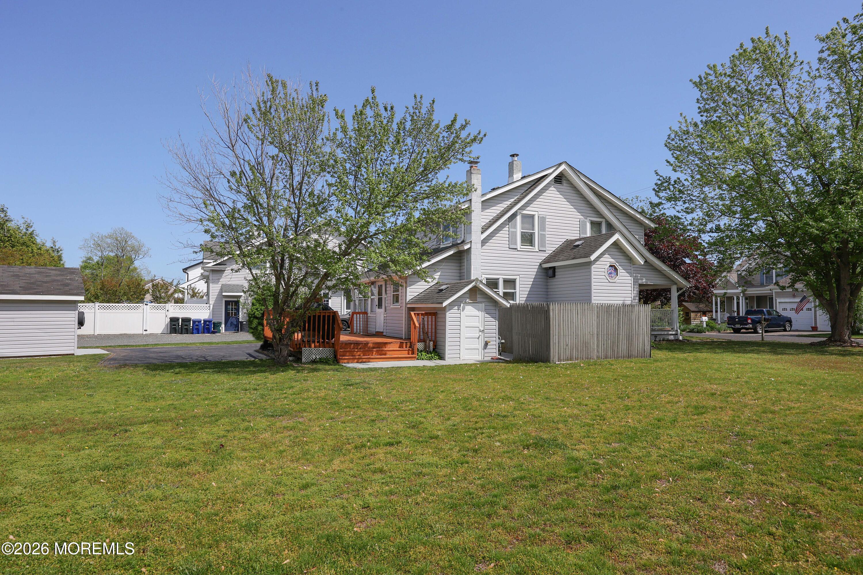 715 Howe Street Point Pleasant, NJ 08742 - Photo 29 of 45 a front view of a house with a garden and trees