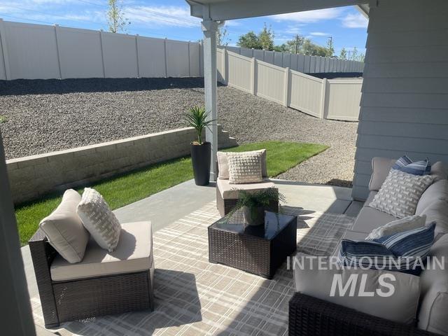 2035 Sumac Avenue Middleton, ID 83644 - Photo 15 of 17 Covered patio with concrete flooring, framed by a concrete block retaining wall and partial lawn