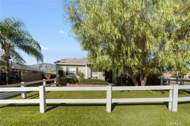 a view of house with swimming pool and a bench
