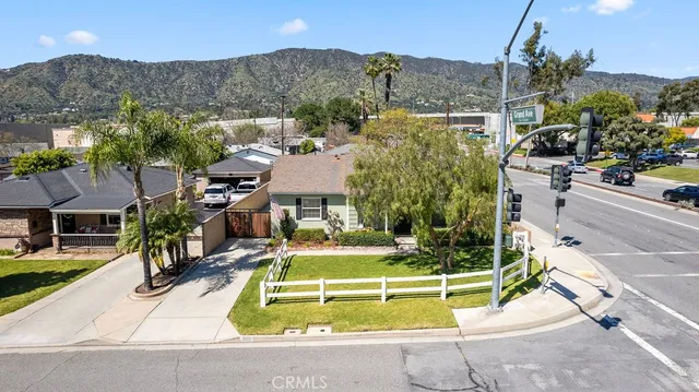 a view of a house with a swimming pool and a yard