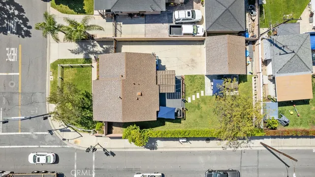 an aerial view of multiple houses with yard