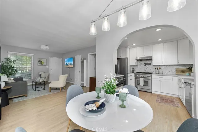 a view of a dining room with furniture and chandelier