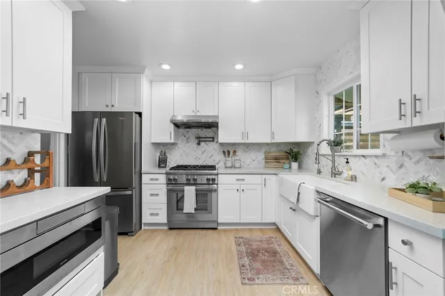 a kitchen with a sink stove and refrigerator