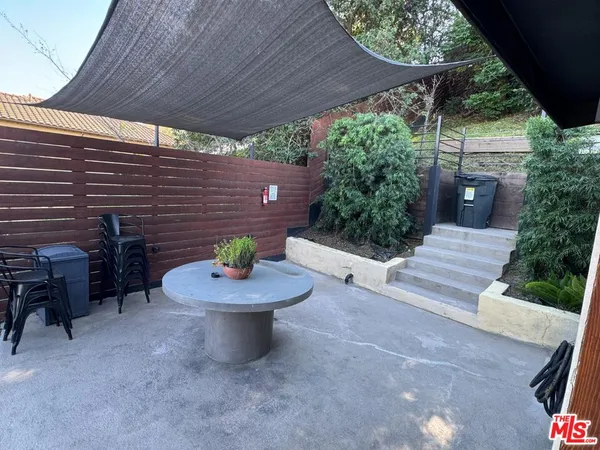 a backyard of a house with outdoor seating