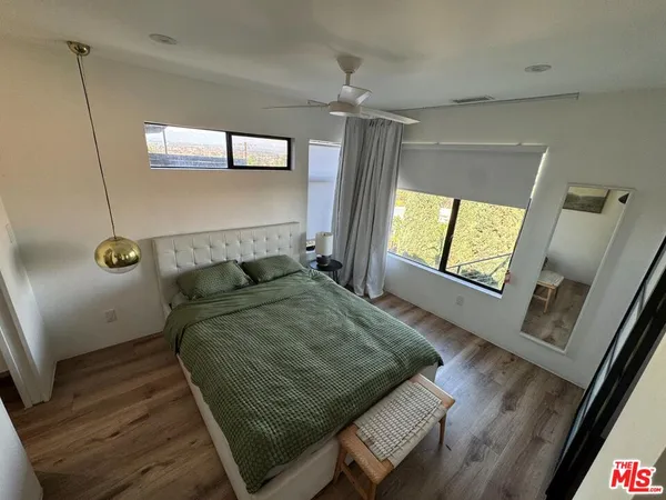 a bed sitting in a room next to a window