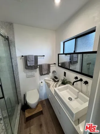 a bathroom with a toilet sink and mirror