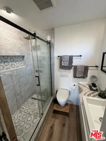 a bathroom with a toilet sink and shower