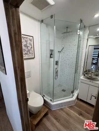 a bathroom with a shower a toilet and sink