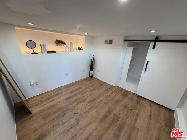 an empty room with wooden floor