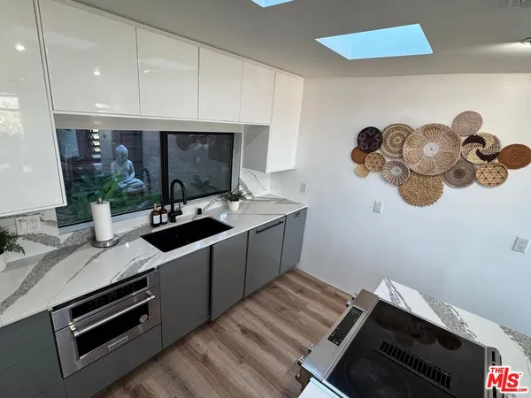 a kitchen with a sink appliances and cabinets