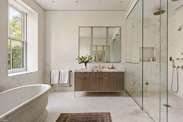 a bathroom with a tub sink and mirror