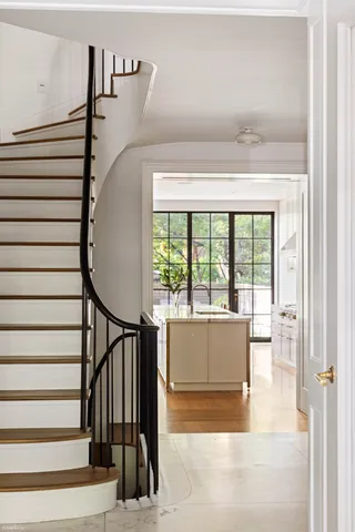 a view of entryway and hall with wooden floor
