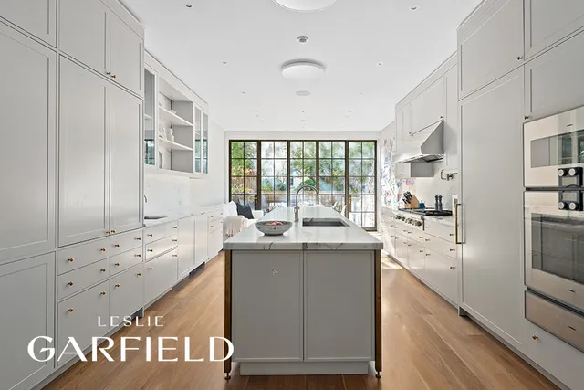 a kitchen with granite countertop a sink and cabinets