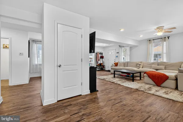 a kitchen with granite countertop a refrigerator sink and white cabinets