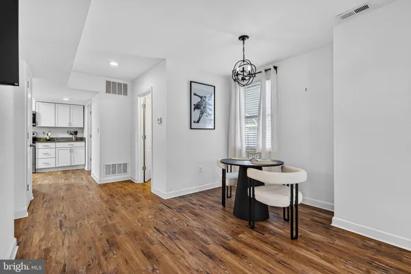 a large kitchen with cabinets stainless steel appliances and a counter space