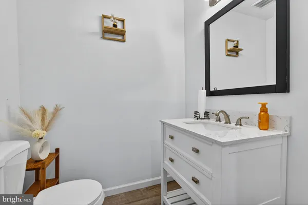 a bedroom with a bed and a flat tv screen on wall