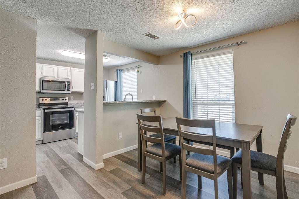7312 Strawberry Way Fort Worth, TX 76137 - Photo 14 of 40 a view of a dining room with furniture and wooden floor