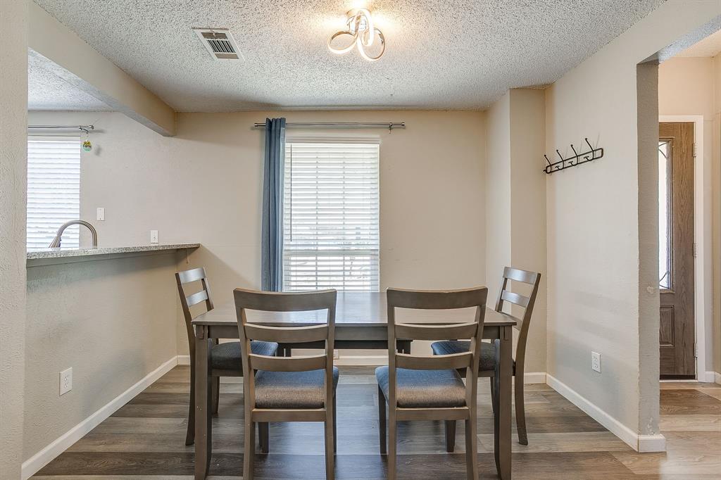 7312 Strawberry Way Fort Worth, TX 76137 - Photo 15 of 40 a view of a dining room with furniture and a window