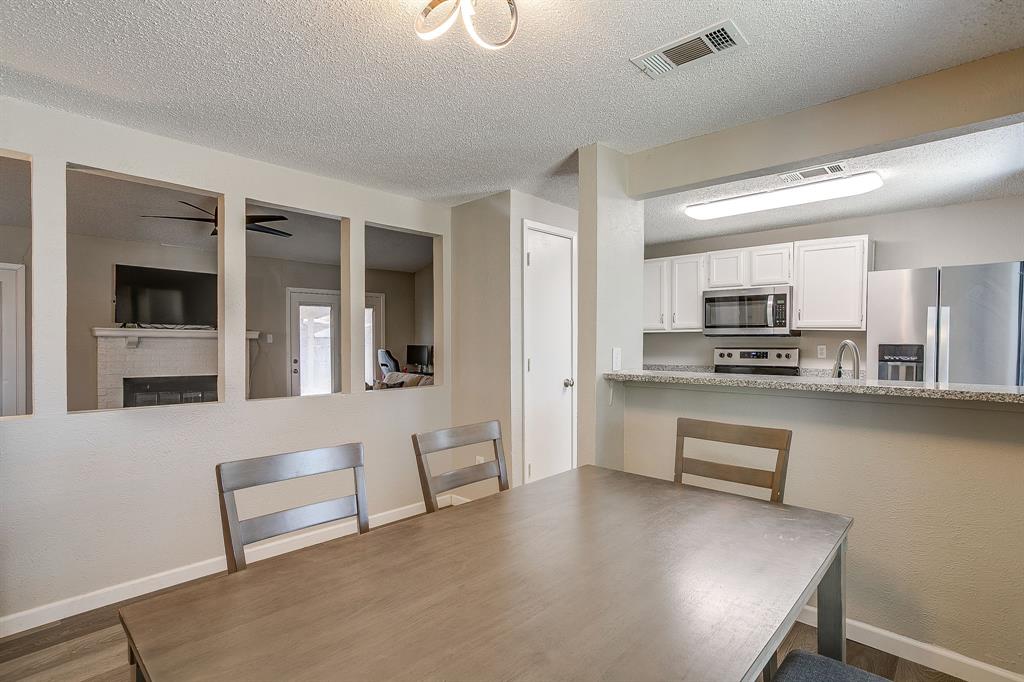 7312 Strawberry Way Fort Worth, TX 76137 - Photo 18 of 40 a kitchen with stainless steel appliances granite countertop a refrigerator a stove and a sink with granite countertops
