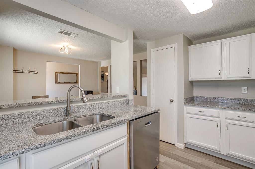 7312 Strawberry Way Fort Worth, TX 76137 - Photo 22 of 40 a kitchen with granite countertop a sink and cabinets