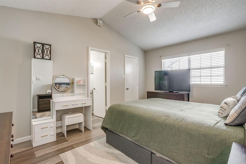 7312 Strawberry Way Fort Worth, TX 76137 - Photo 24 of 40 a bedroom with a bed and a chandelier