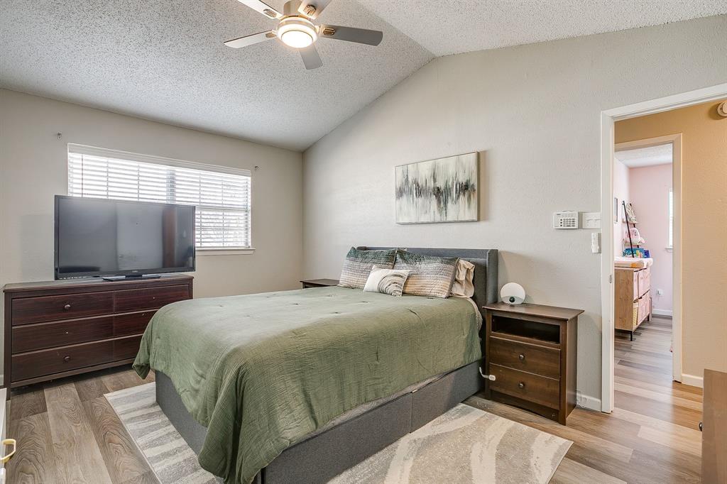 7312 Strawberry Way Fort Worth, TX 76137 - Photo 25 of 40 a bedroom with a bed and a flat screen tv