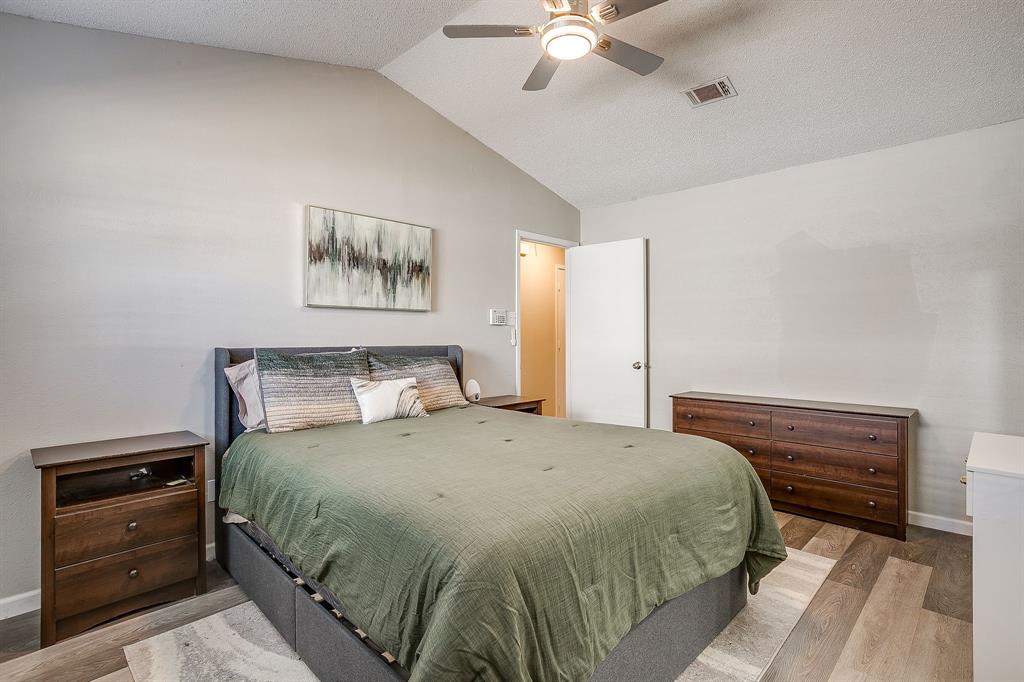 7312 Strawberry Way Fort Worth, TX 76137 - Photo 26 of 40 a bedroom with a bed and a chandelier