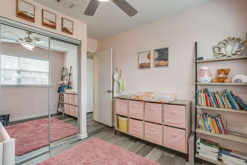 7312 Strawberry Way Fort Worth, TX 76137 - Photo 32 of 40 a bedroom with furniture and a book shelf