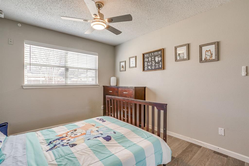 7312 Strawberry Way Fort Worth, TX 76137 - Photo 35 of 40 a bedroom with a bed and a window